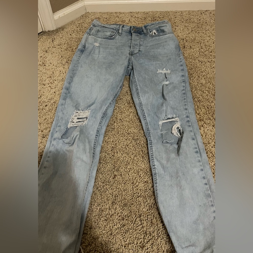 Light colored ripped straight cut jeans